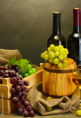 Photo: barrel, bottles and glasses of wine and ripe grapes barrel, bottles and glasses of wine and ripe grapes