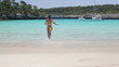 Sexy woman in bikini running into the sea, slow motion