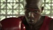 Young black man exercising as boxer in boxing gym