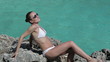 Video: Happy woman in bikini sunbathing by turquoise sea Happy woman in bikini sunbathing by turquoise sea