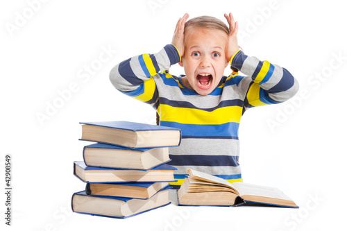 Foto: schoolgirl with horror looking at pile of books schoolgirl with horror looking at pile of books