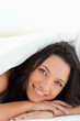 Green eyed woman under the duvet