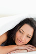 Cute woman under the duvet