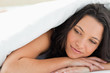 Beautiful woman under a duvet