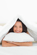 Close-up of a cute woman hugging a pillow
