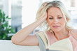 Blonde female reading a book