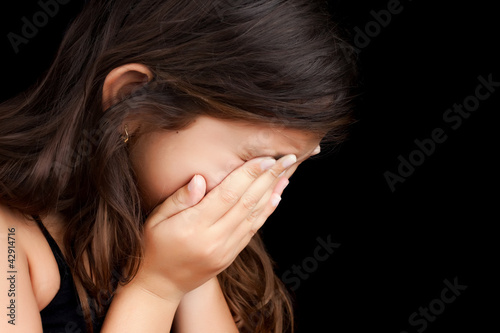 Photo: Portrait of a girl crying and hiding her face Portrait of a girl crying and hiding her face