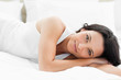 Pretty woman lying on her bed