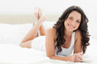 Pretty brunette lying on her bed