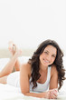 Close-up of a pretty brunette lying on her bed