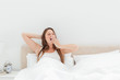 Cute woman yawning in her bed