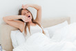 Beautiful woman yawning and stretching her arms