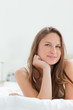 Cute woman lying down on a bed