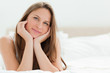 Portrait of a young woman lying on her bed