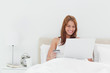 Happy redheaded using her credit card online 
