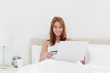Portrait of a redheaded using her credit card online 