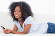 Portrait of a happy brown woman using a smartphone
