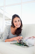 Portrait of a beaming student leafing through a magazine