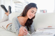 Beaming student leafing through a magazine