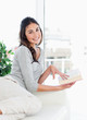 Portrait of a beaming brunette holding a novel