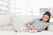 Brunette reading on her sofa 