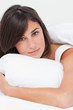 Portrait of a brunette in her bed