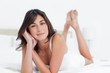 Portrait of a charming woman on her bed