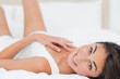 Portrait of a charming brunette lying on her back