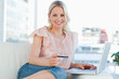 Portrait of a blonde buying online with a laptop
