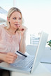 Close-up of a blonde thinking to shop online