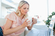 Blonde on a laptop with a tea