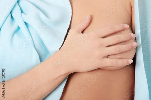 Photo: Woman is covering naked breast. Woman is covering naked breast.