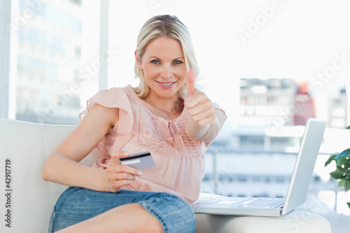 Photo: Blonde approving the shopping online Blonde approving the shopping online
