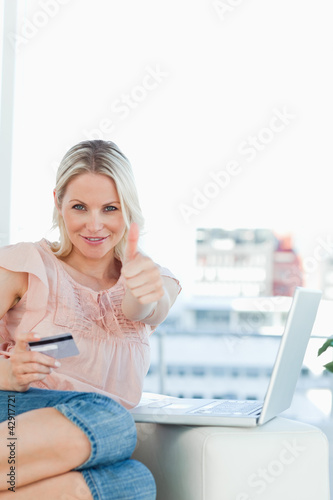 Photo: Close-up of a blonde approving the shopping online Close-up of a blonde approving the shopping online