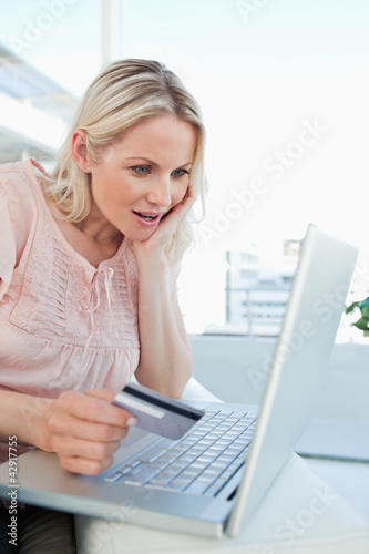 Photo: Blonde surprised about a shop online Blonde surprised about a shop online