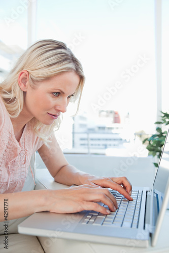 Photo: Concentrated blonde on a laptop Concentrated blonde on a laptop