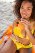 Young woman looking at the camera while drinking an exotic cocktail