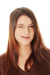 Young beautiful woman is smiling and winking.