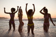 Young women showing their happiness at sunset