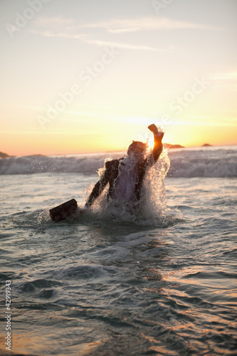Photo: Young businessman getting in the water Young businessman getting in the water