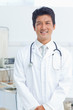 Photo: Doctor smiling happily as he looks ahead Doctor smiling happily as he looks ahead