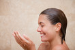 Side view of smiling woman enjoying a shower