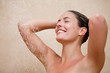 Smiling woman enjoying a shower