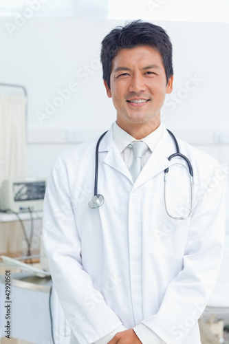 Photo: Doctor smiling happily as he looks ahead Doctor smiling happily as he looks ahead