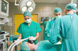 Surgical team operating a patient