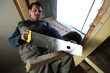 Carpenter using handsaw
