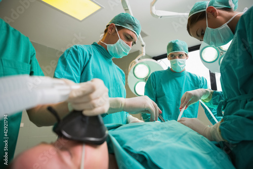 Photo: High view of a surgical team operating High view of a surgical team operating