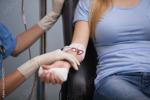 Photo: Female patient giving her blood Female patient giving her blood