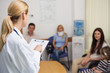 Female doctor talking to patient in a waiting room