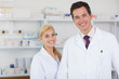 Two pharmacists standing behind a counter